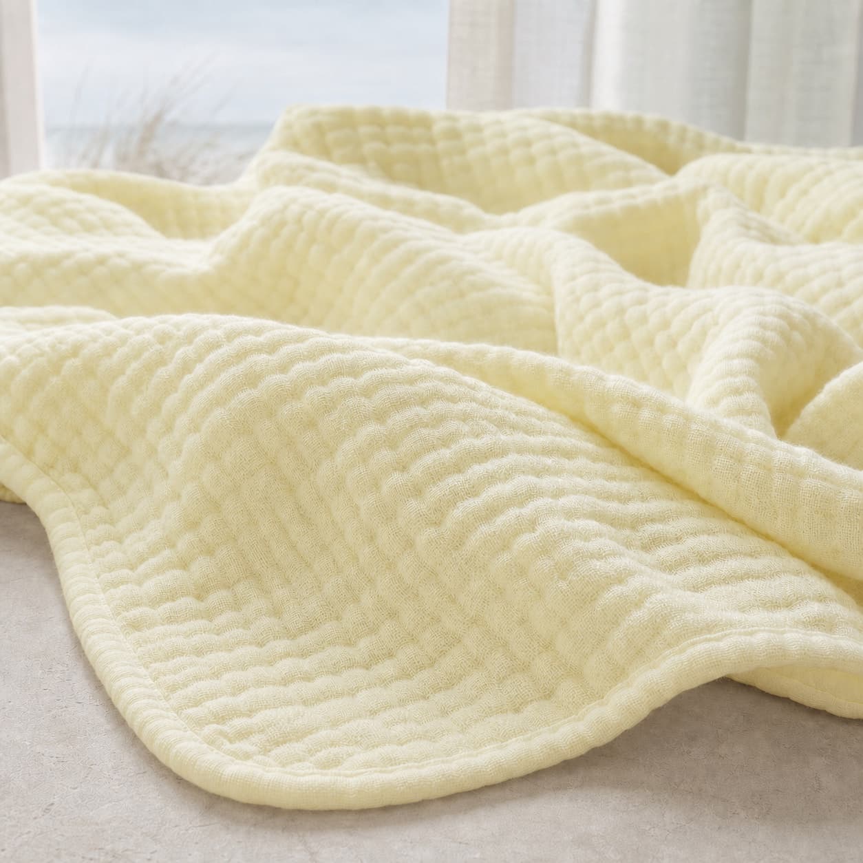 Close-up of the lightweight muslin blanket texture — Sunlit Sand