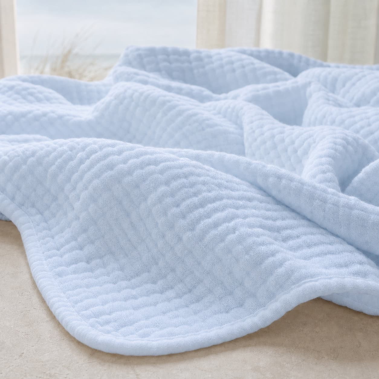 Close-up of the lightweight muslin blanket texture — Sky Blue