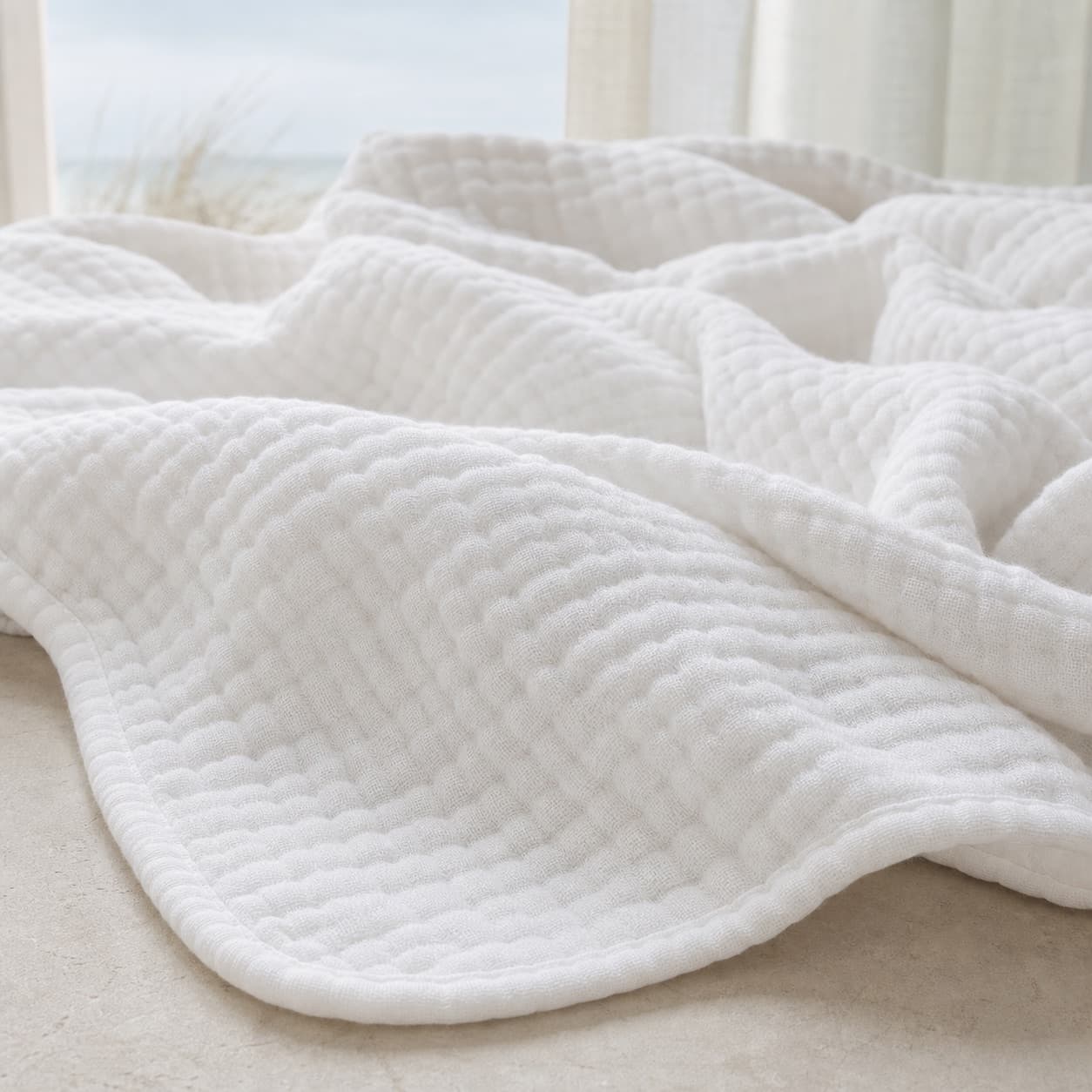 Close-up of the lightweight muslin blanket texture — Cloud White
